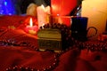 Burning red candles, heart shaped candles, ruby Ã¢â¬â¹Ã¢â¬â¹beads on the table. February 14 decoration. Royalty Free Stock Photo